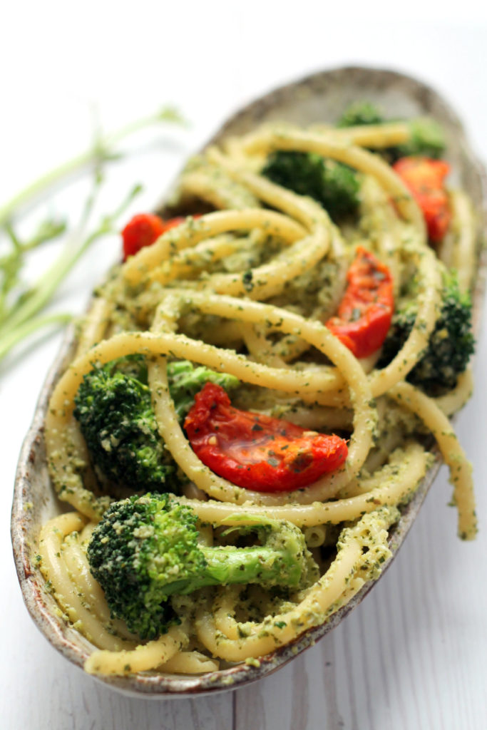 Use a whole broccoli in this pasta dish by turning the stems into a fresh, lemony basil and broccoli pesto. A light, healthy, vegetarian + vegan pesto pasta dinner, ready in 25 minutes.