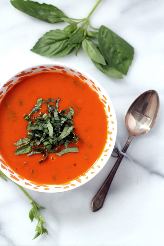 This dairy free tomato soup is incredibly rich and creamy thanks to the addition of roasted garlic! Vegan and gluten free, a total crowd pleaser.