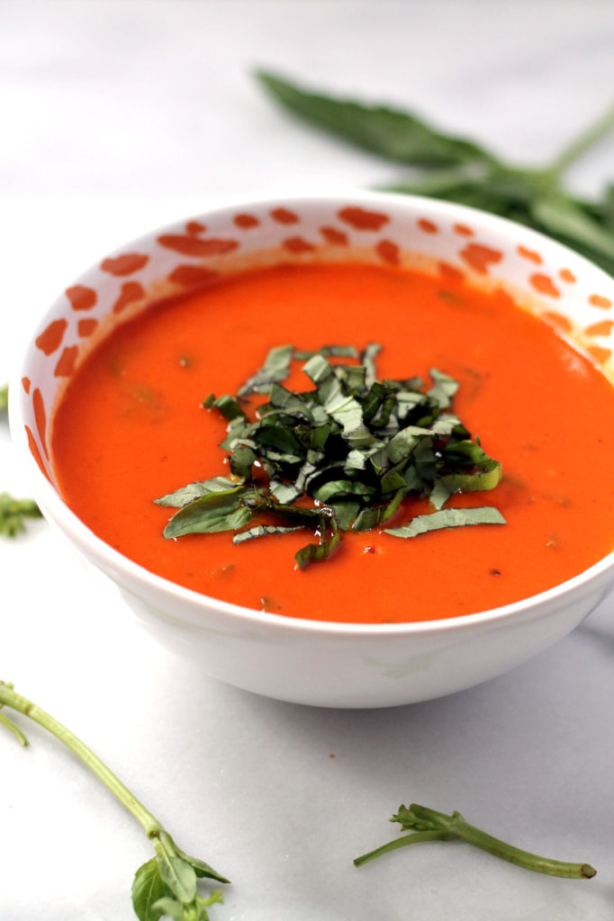 This dairy free tomato soup is incredibly rich and creamy thanks to the addition of roasted garlic! Vegan and gluten free, a total crowd pleaser.