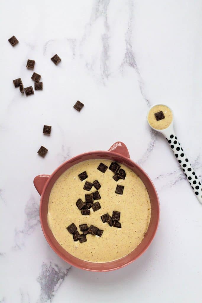 Bowl of almond butter pudding for a toddler. With chocolate chips on top.