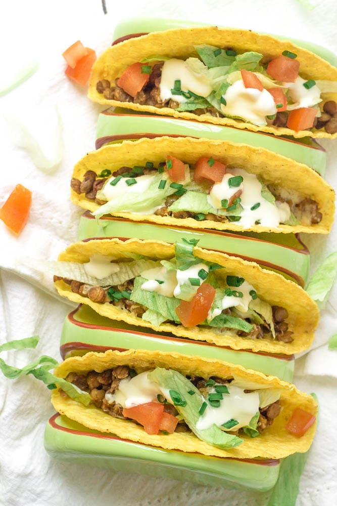 Four lentil tacos with toppings.