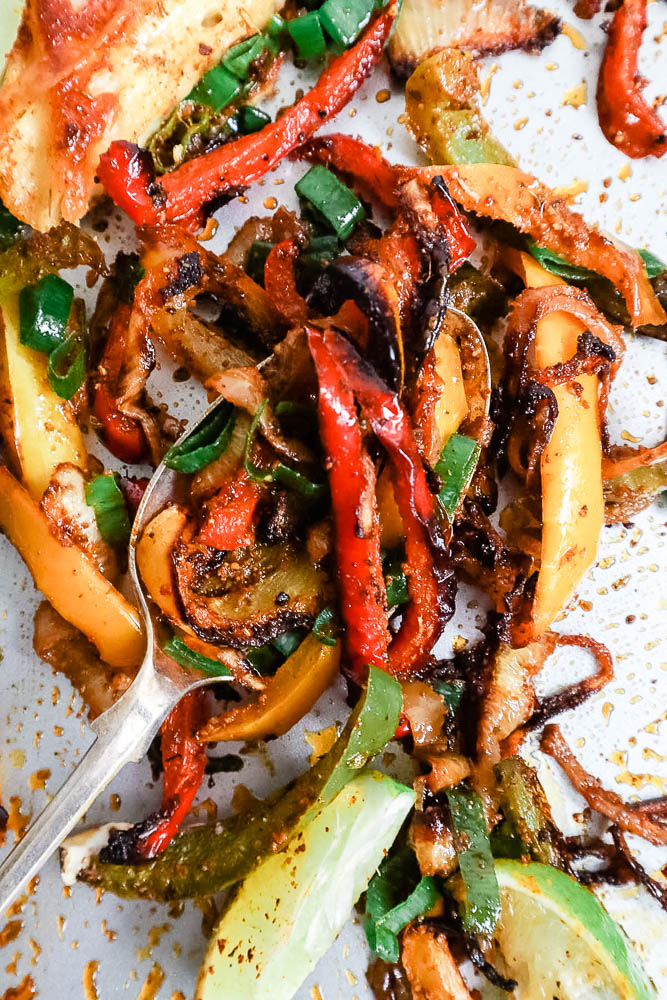 Close up of roasted halloumi fajitas - showing the charred peppers and onions