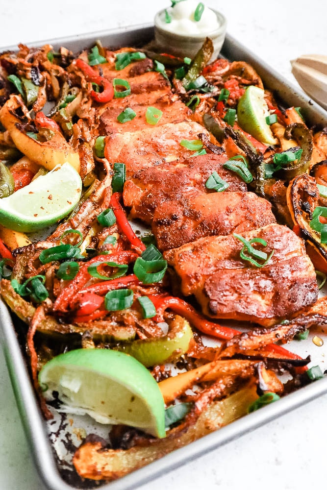 A baking tray with cooked roasted halloumi fajitas