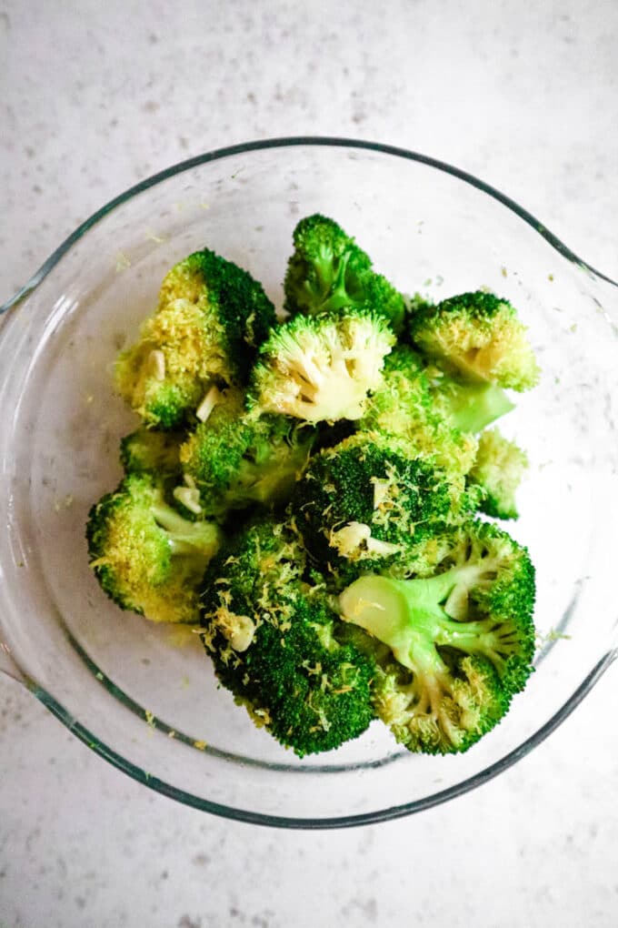 Broccoli prepped with oil, lemon zest and garlic.
