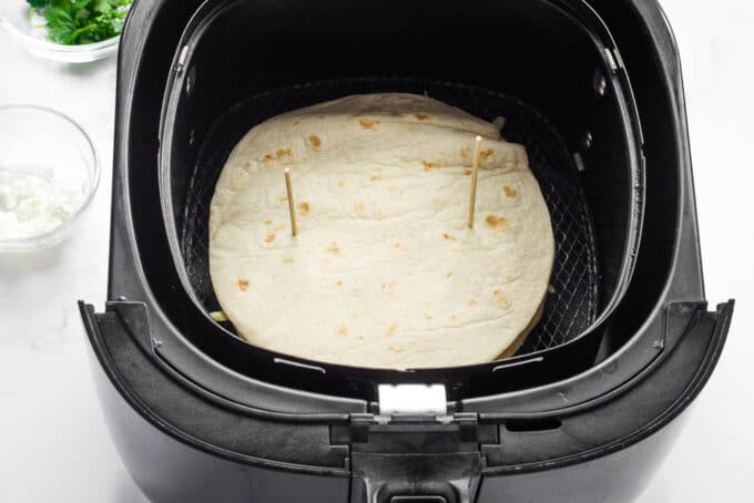 An uncooked quesadilla in the air fryer