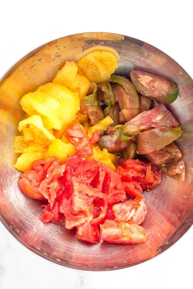 A bowl of peeled heirloom tomatoes