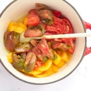 Peeled heirloom tomatoes in a pan