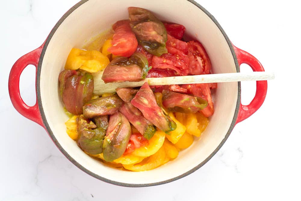 Peeled heirloom tomatoes in a pan