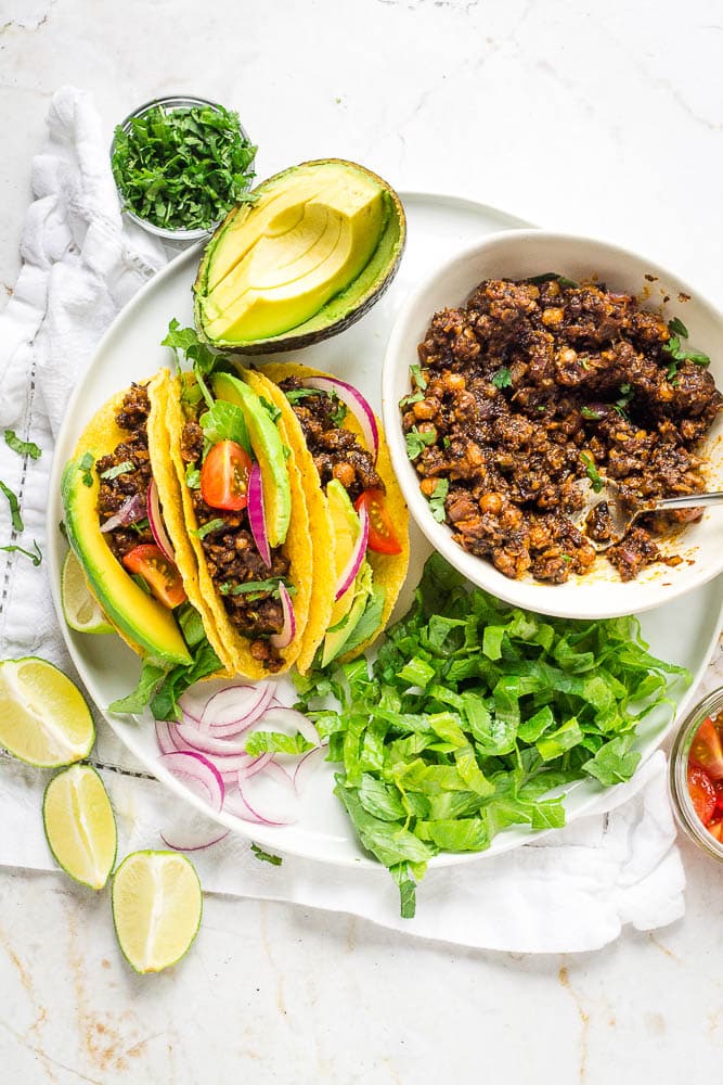Vegan tacos plated up with toppings