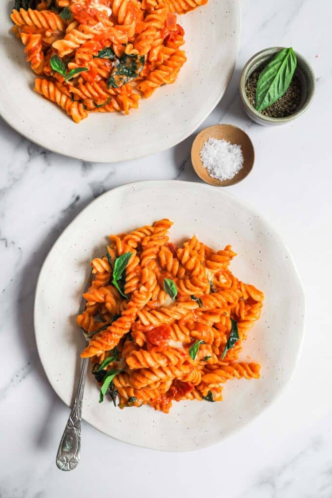 Two plated portions of tomato mascarpone pasta