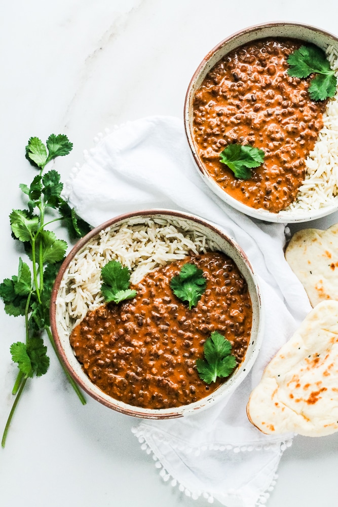 Two bowls of black dal with rice